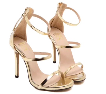 a pair of gold high heel sandals