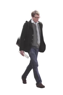 a man in a coat and tie walking down the street