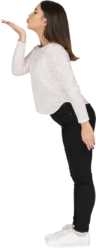 a woman in black pants and a white sweater