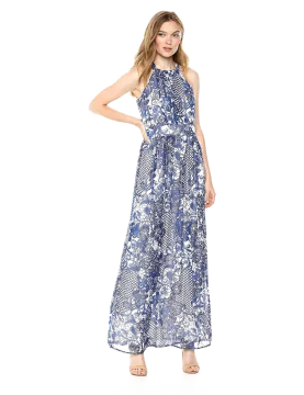 a woman wearing a blue and white floral print maxi dress