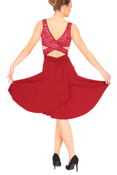 a woman wearing a red dress and black heels