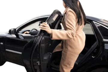a woman is opening the door of her car
