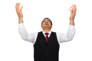 a man in a suit and tie is raising his hands