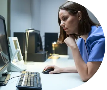 a woman sitting in front of a computer