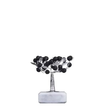 a silver vase with black flowers on it