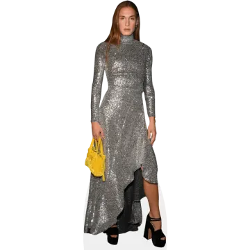 a woman wearing a silver dress and black heels