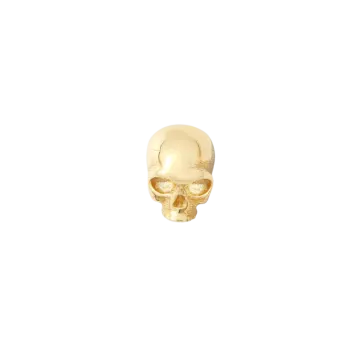 a gold skull ring on a white background