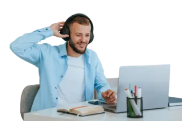 a man sitting at a desk with headphones on