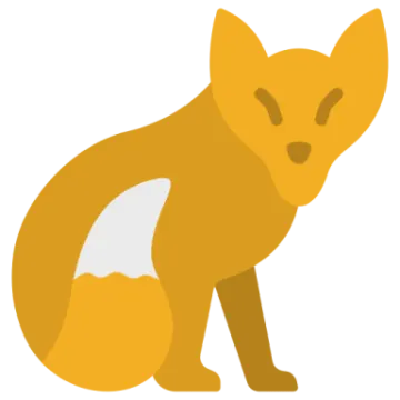 an orange fox sitting on the ground