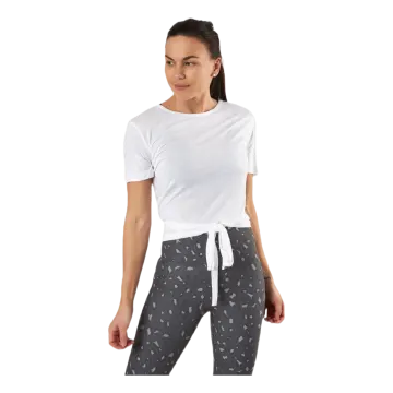 a woman wearing a white t - shirt and black pants
