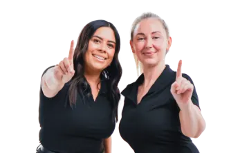 two women giving a thumbs up sign