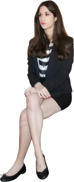 a woman sitting on the ground with her legs crossed