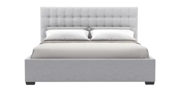 a bed with a light gray upholing