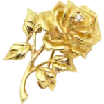 a gold rose with leaves on it