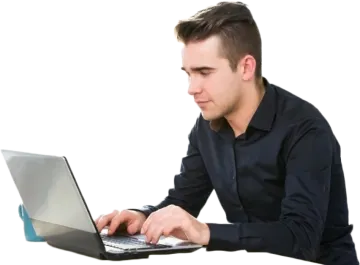 a man sitting at a table using his laptop
