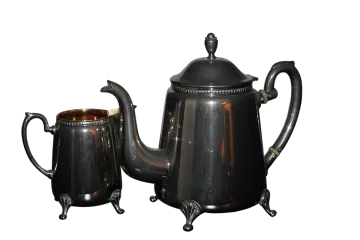 a black coffee pot and a silver teapot