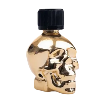 a gold skull shaped bottle with a black cap