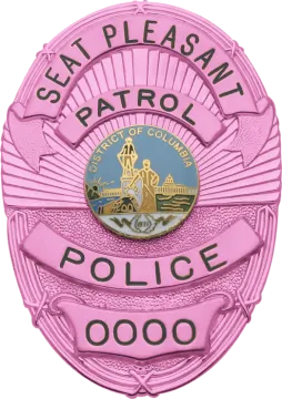 a pink police badge with the words capitol police