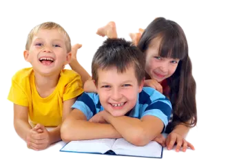 three children laying on the floor and smiling