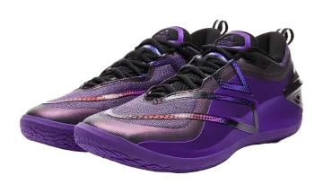 a pair of purple and black basketball shoes