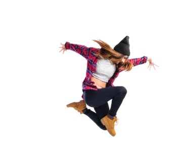 a woman jumping in the air with her arms outstretched