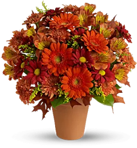 a vase filled with orange and red flowers