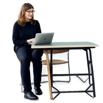 a woman sitting at a desk using a laptop