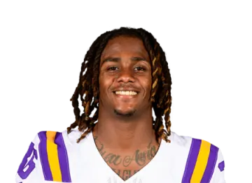 a man with dread hair wearing a football uniform