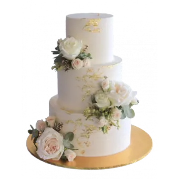 a white and gold wedding cake with flowers