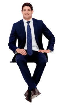 a man in a suit and tie sitting on a chair