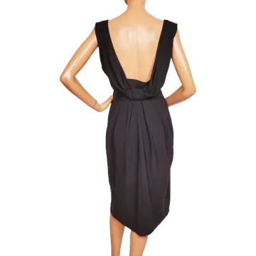 a woman wearing a black dress with an open back