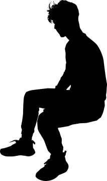a silhouette of a man sitting on the ground