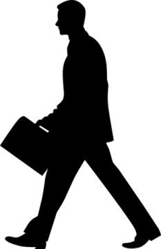 a silhouette of a man walking with a briefcase