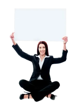 a woman sitting on the floor holding up a sign