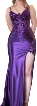 a woman in a purple dress posing for the camera