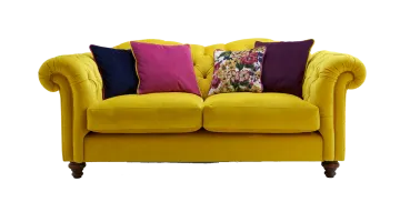 a yellow couch with colorful pillows on it