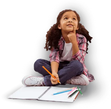 a little girl sitting on the floor and drawing