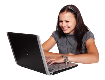 a young woman is typing on her laptop
