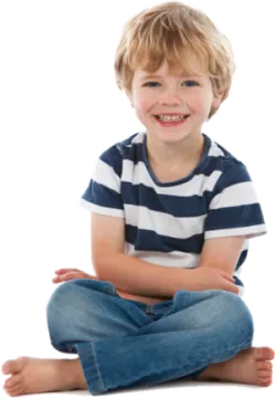 a little boy sitting on the floor with his legs crossed