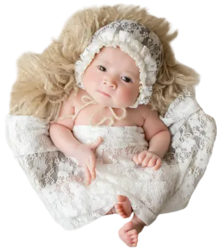 a baby doll in a white dress and bonnet