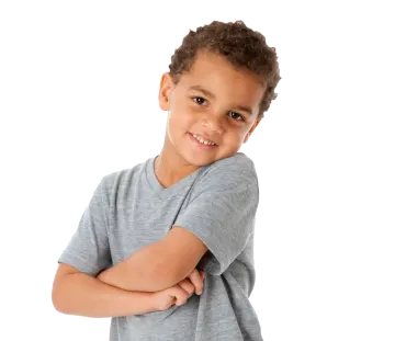 a young boy standing with his arms crossed