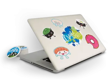 a laptop computer with stickers on it
