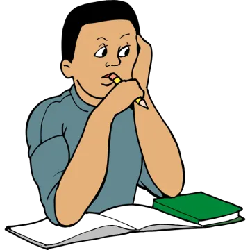 a boy sitting at his desk reading a book