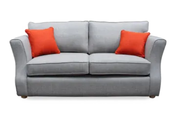 a grey sofa with orange pillows