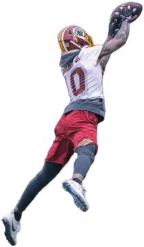 a man in the air catching a football ball