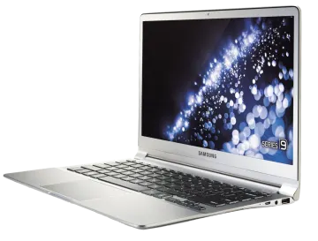 an open laptop computer on a white surface