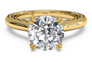 a yellow gold engagement ring with a round brilliant diamond