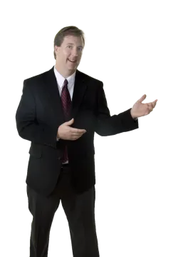 a man in a suit and tie with his hands out