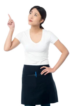 a woman in an apron pointing at something