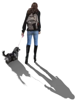 a woman walking her dog on a leash